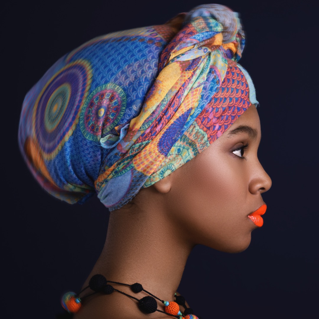 Portrait of African woman with a colorful traditional shawl on her head